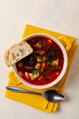 Traditional Spanish goulash soup. Fabada Asturiana. Served with a yellow clay pot with lid. Top...