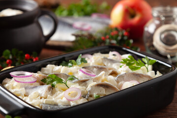 Herring fillet salad in cream with apple.