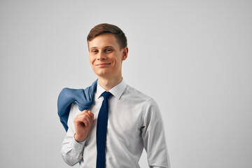 man in shirt with tie and jacket on his shoulders fashion work