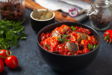 Herring fillet salad in tomato sauce.