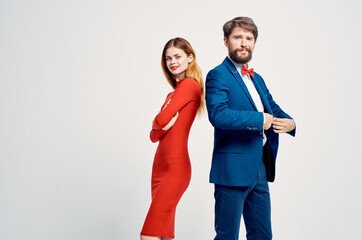 a man in a suit next to a woman in a red dress romance happy isolated background