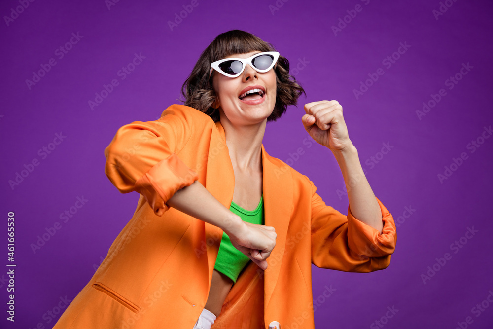 Canvas Prints Photo of funky sweet young lady wear orange jacket dark glasses smiling dancing isolated violet color background