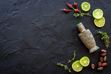 Agar wood tree oil perfume in silver bottle with spices and fruits