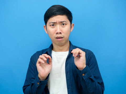 Asian man gesture scare and feeling afriad something blue background
