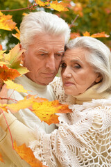 portrait of sad senior couple in the park