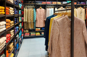Pune ,INDIA, 2 October 2021 : Indian men latest fashion dress hung on hangers, in display in retail...