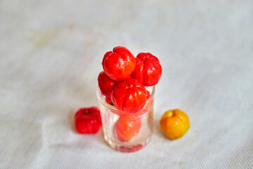 closeup the spanish cherry ripe in glass cup on white background