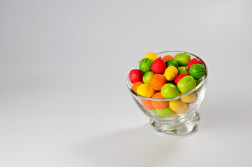 Multi-colored dragee gummies in the form of various fruits of lemon, raspberry, strawberry, watermelon and others.