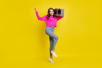 Full size photo of young attractive girl happy positive smile hold retro boombox music isolated over yellow color background