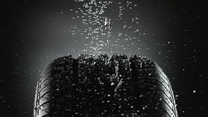 Super slow motion of falling rain on rotating tire sample, close-up. Filmed on high speed cinema camera, 1000 fps.