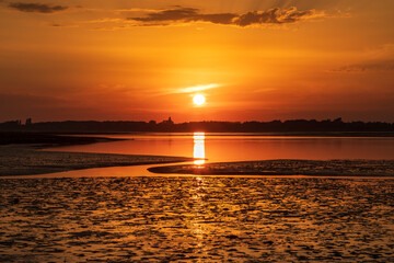 Pagham Harbour nature reserve sunset at low tide.