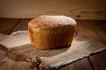 A loaf of delicious white bread made from natural products, on hops with flax saturation, without...