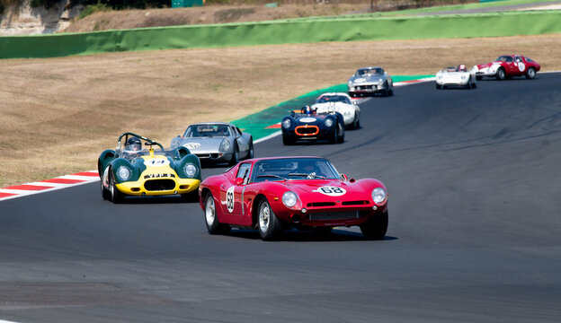 60s vintage race car competition on racetrack, Bizzarrini 5300 GT TZ leading group