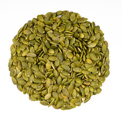 Peeled pumpkin seeds on a white isolate.