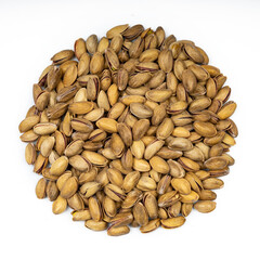 Unpeeled pistachios on a white isolate.