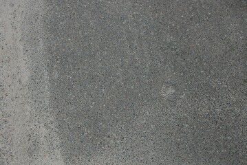 gray stone background of dirty asphalt on the road in the street