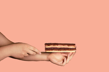 a cake on a background with a woman's hand is a modern dish of a minimalistic concept that copies the space. The concept of a cafe or bakery with desserts. your choice, a good offer. profitable.