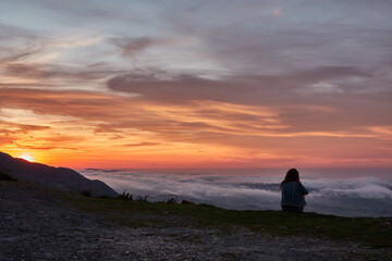 Clouds descend over Playa de la Isla at sunset. Asturias. Spain