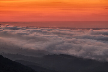 Clouds descend over Playa de la Isla at sunset. Asturias. Spain