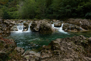 Fototapeta na wymiar Senda De La Hoya De San Vicente across the Dobra River in the Ponga Natural Park in Asturias. Spain