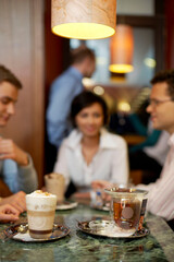 Business people enjoying latte at table in coffee shop