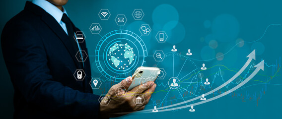 Businessman using mobile smartphone and icon network connection data with customer growth graph, digital marketing, online banking and payment, and company analysis and planning.