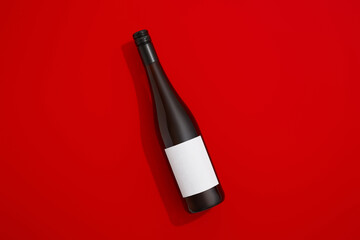 Wine bottle with blank label. Red wine on colorful background with copy space