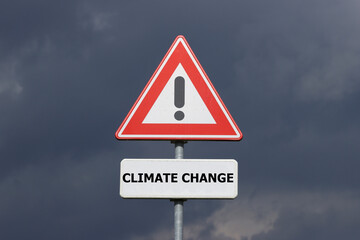A sign with a exclamation mark warning for a dangerous situation ahead and a smaller sign below with the English text Climate Change on it