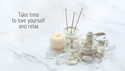 Take time to love yourself and relax - inspiration quote. candle, quartz minerals, Buddha statue, aroma sticks on marble background. esoteric spiritual practice for aura cleansing, relax, life balance