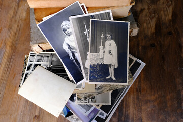 stack of vintage photos, retro photography of 1940-1950 on wooden table, old books, concept of...