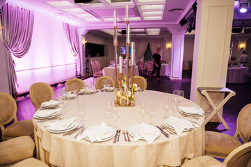 Banquet decorated table, with cutlery. Wedding decor in the banquet hall.