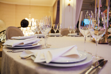 Banquet decorated table, with cutlery. Wedding decor in the banquet hall.