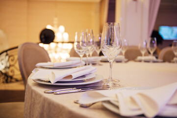 Banquet decorated table, with cutlery. Wedding decor in the banquet hall.