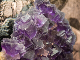 Session of precious minerals and rocks. Macro photo of Fluorite. Rocks and minerals exhibited in a museum. Gemstones, rocks and jewelry minerals. Reflections and textures of colorful minerals.