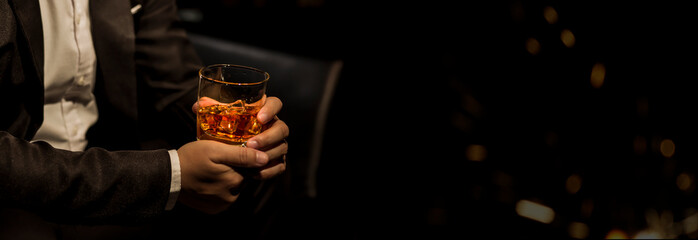 Closeup businessmen holding a glass of whiskey