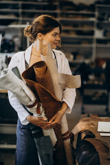 Woman tailor working on leather fabric