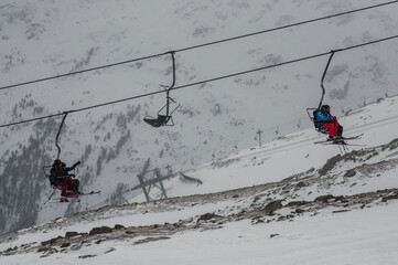SOELDEN, AUSTRIA - JANUARY 23 2012: Skiers take the chairlift up the mountain