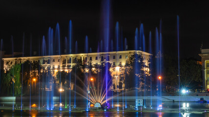 Multicolored musical fountain on a river at night. The fountain in the night from illumination. Long exposure.