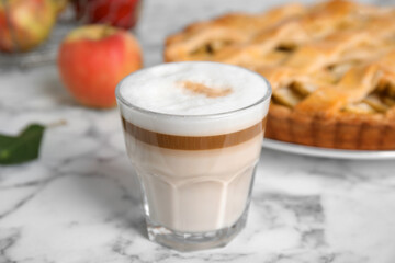 Glass of coffee and traditional apple pie on white marble table