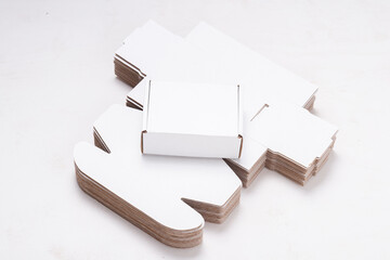 Lot of unfolded cardboard boxes ov wooden desk