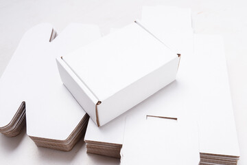 Lot of unfolded cardboard boxes ov wooden desk