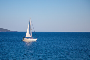 Fototapeta premium View of small yacht boat sailing in calm open sea in Montenegro 