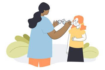 Optometrist cartoon character giving glasses to kid at hospital. Medical appointment, ophthalmologist examining eyes of children flat vector illustration. Vision therapy, concept for website design - obrazy, fototapety, plakaty