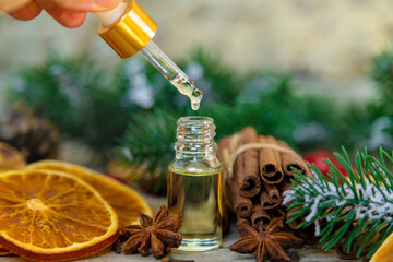 Christmas essential oils in small bottles. Selective focus. - obrazy, fototapety, plakaty