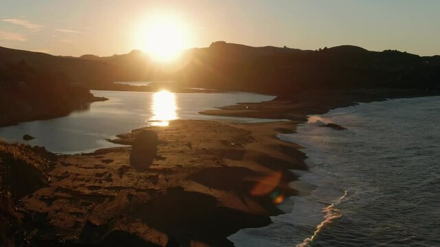 Aerial: Sunrise over Goat Rock Beach and the Russian River on the Mendocino Coastline. Jenner, California, USA