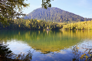 A beautiful autumn landscape.Reflection of the mountain and trees in the lake. Orthodox Chapel on...