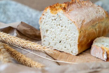Freshly baked loaf of bread on a wooden board.