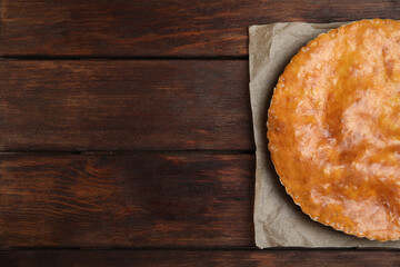 Delicious pie with meat on wooden table, top view. Space for text