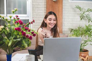 An engaged young lady listening intently to a entertaining video conference streaming on her...