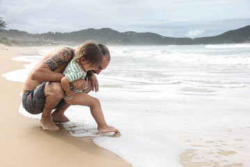 Boy discovering the sea with his father